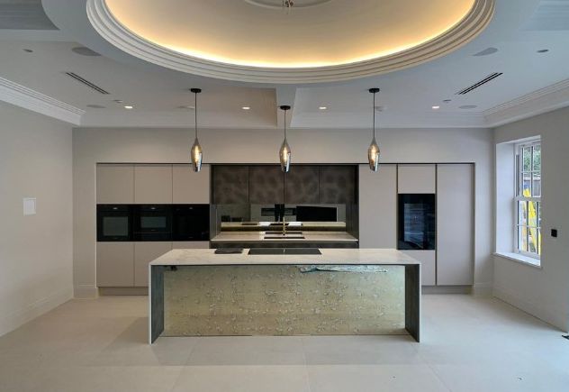 Kitchen with island and cove-lit ceiling at Herbert Road